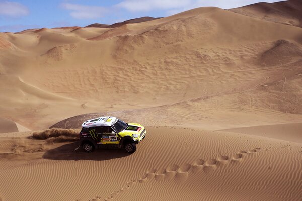 Dakar Rally. The SUV is driving through the desert