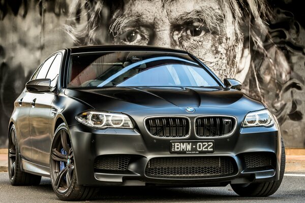 Black BMW m5 on the background of the picture