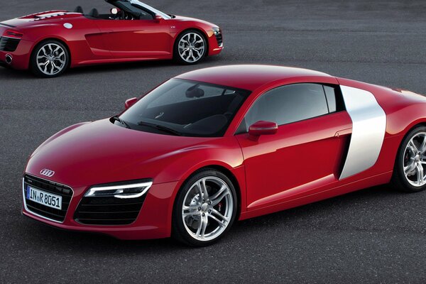 Two beautiful red Audi r8s on the road