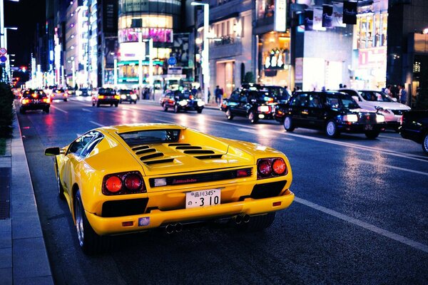 Yellow lamborghini diablo on the background of city streets