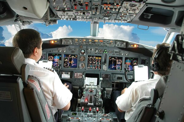 Pilots in the cockpit monitor the flight