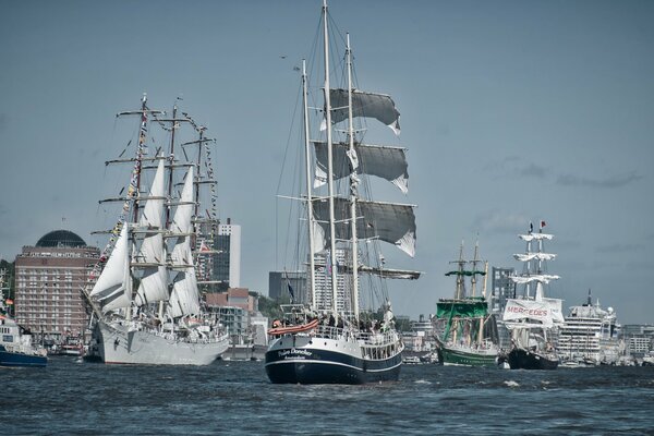 Ships and sailboats on parade in Hamburg on the Elbe River