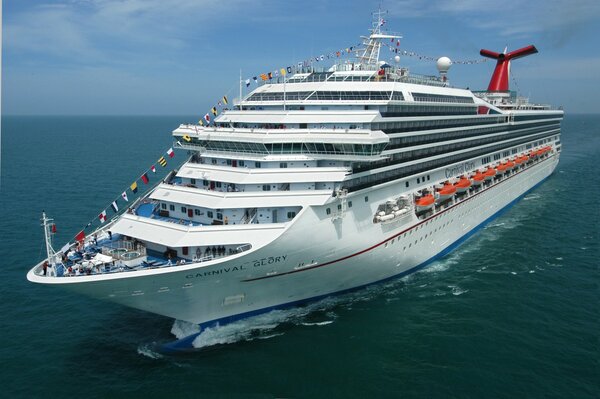 A big white cruise ship sails on the sea