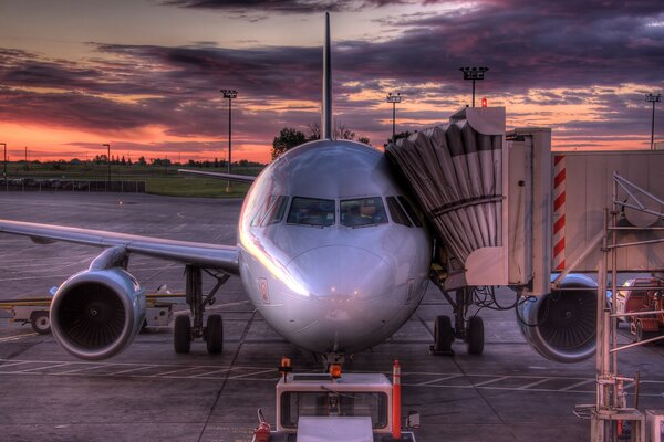 Photo of an airplane at the airfield at sunset