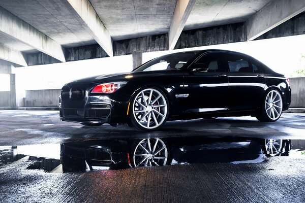 A black bmw even in a garage-type building looks noble