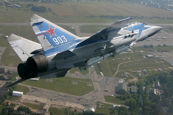 The f35 aircraft performs a turn over the city