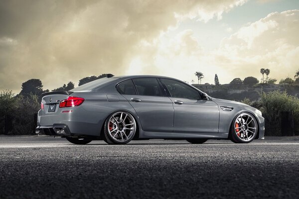 Grey BMW M5 and picturesque landscape