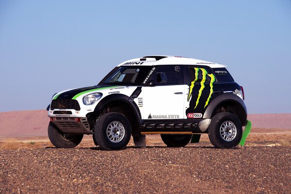 Rallye Dakar. SUV se dresse sur le fond de la colline et le ciel bleu