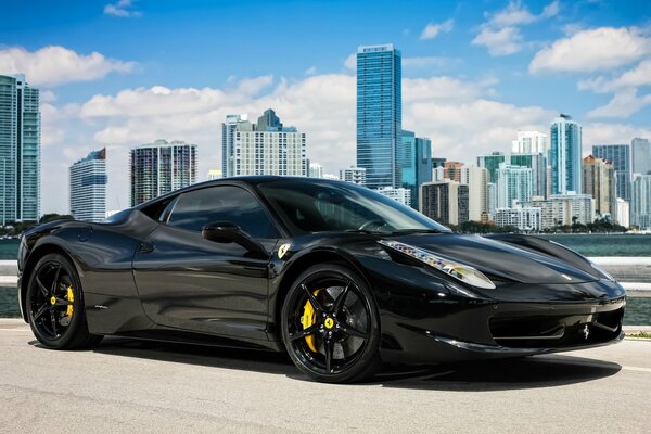 Ferrari black on the background of skyscrapers