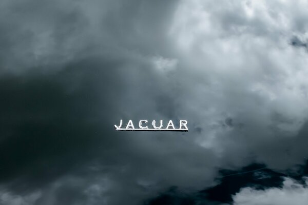 The inscription jaguar metallic on the background of clouds