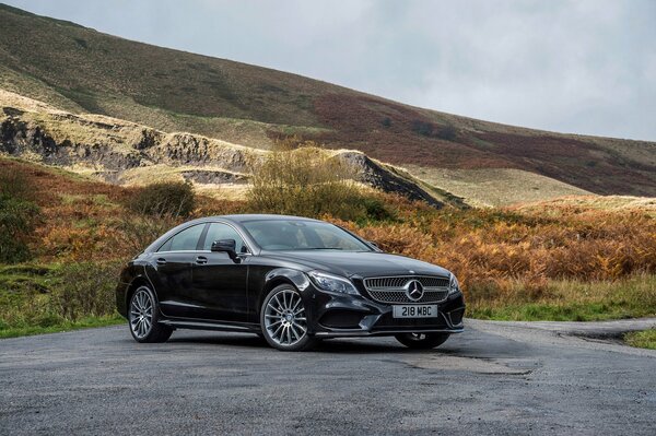 Black Mercedes on the highway in the mountains