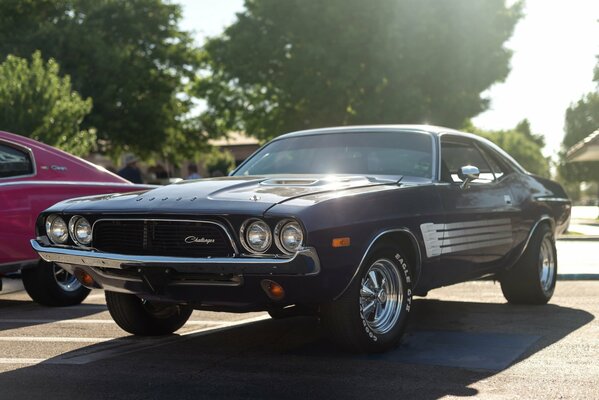 A classic black car is parked in the parking lot