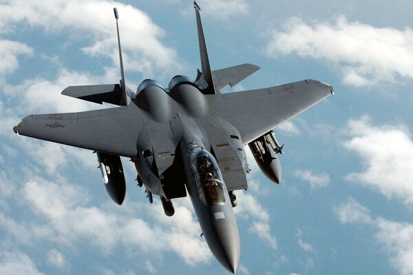 Black F-15 military fighter in the air