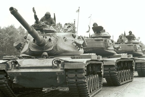 A column of tanks in a black and white photo