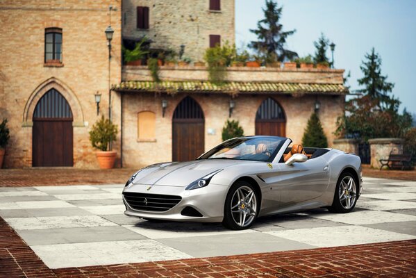 Ferrari on the playground in front of the villa