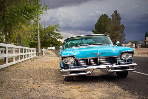 Retro car of blue color on the background of nature