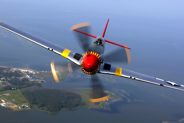 A fighter with propellers flies over the peninsula