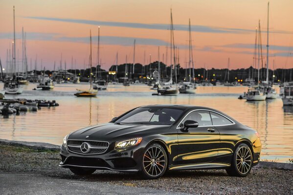 Black Mercedes-Benz S 550 c217 amg 2014 on shore with yachts