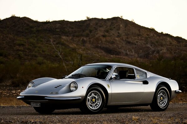 Silver Ferrari in the desert under the scorching sun