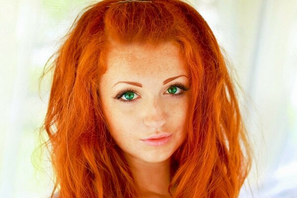 Green-eyed red-haired girl with freckles
