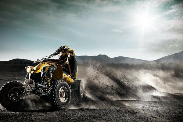 ATV in a skid on the sand under the scorching sun