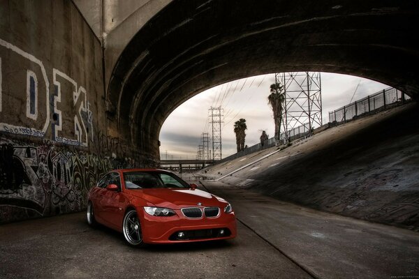 Red BMW under the Canal bridge