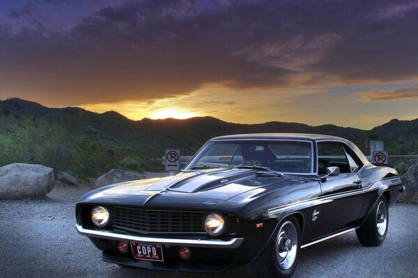 An old intelligent car on the background of a gloomy sunset