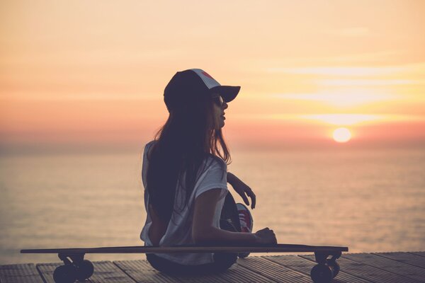 Skater girl on sunset background