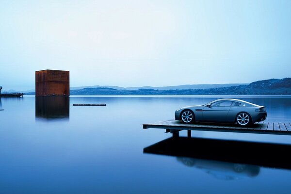 The car is admiring on the pier on the square