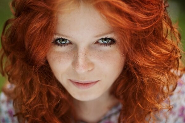 Red-haired curly-haired girl with freckles