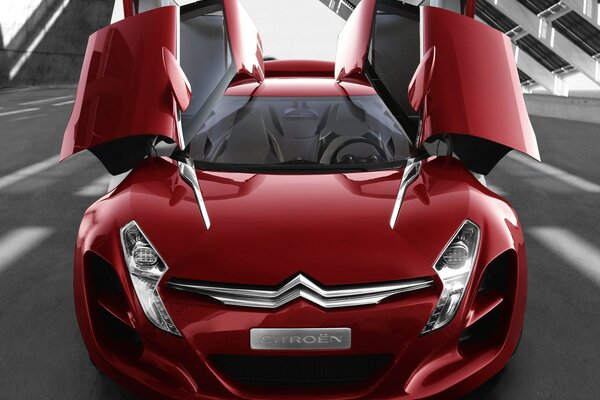 A concept car of a red Citroen four-door with upward-rising doors