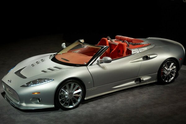 Sports car without top in silver color and red interior