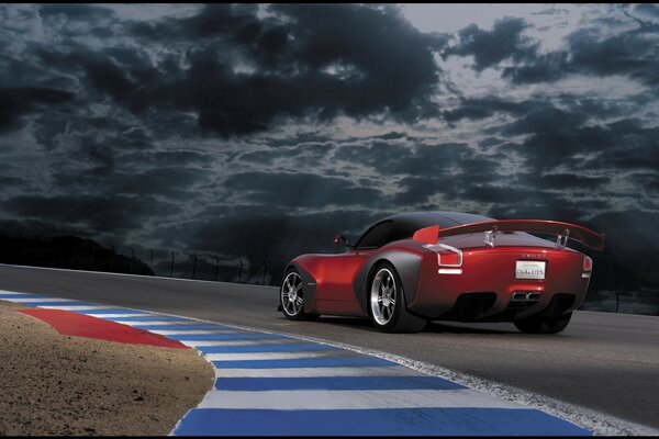 Red car on the highway. There is only a gap between him and the sky