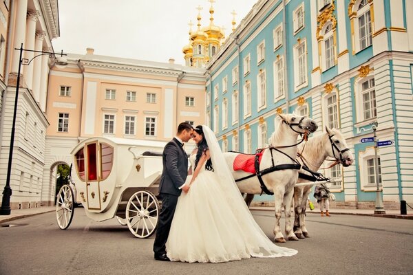 A couple in love near the carriage. Wedding mood