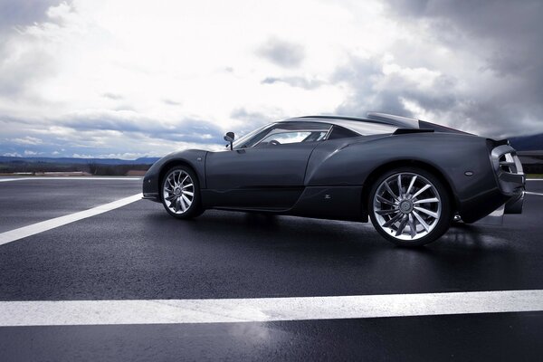 Gray car on gray asphalt under a gray sky on a gray day