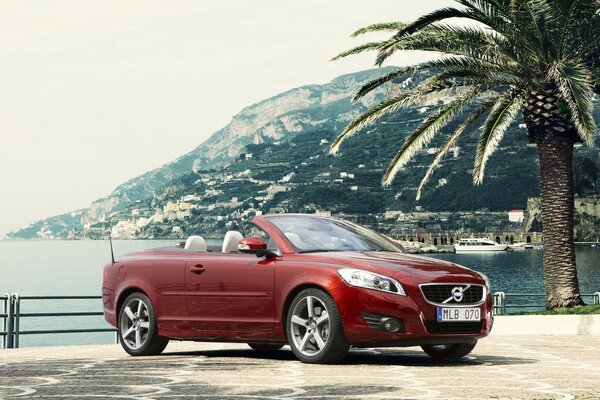 Red Volvo on the background of mountains