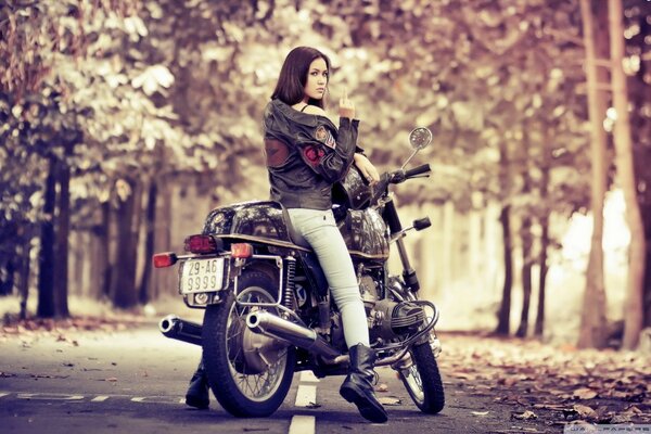 Daring motorcyclist girl autumn