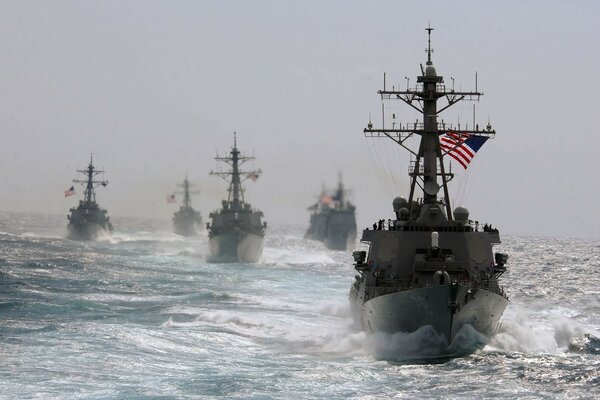 Warships under the flag of the United States in the wind-tossed sea
