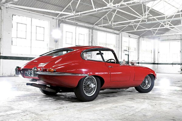 Red retro car in a white garage