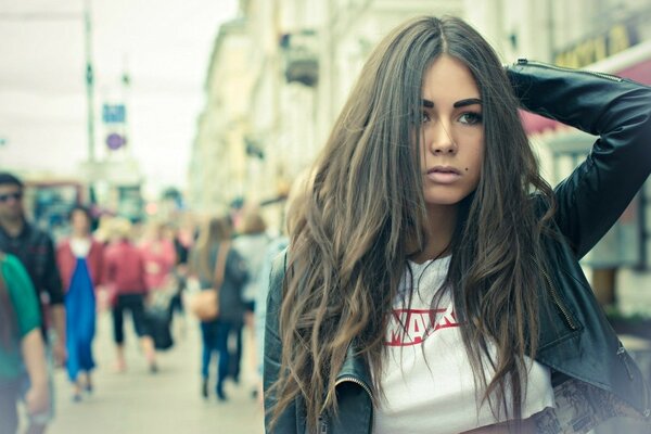 A girl with dark hair and a mole above her lip