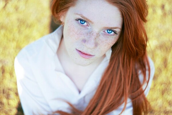 A red-haired girl with freckles and blue eyes