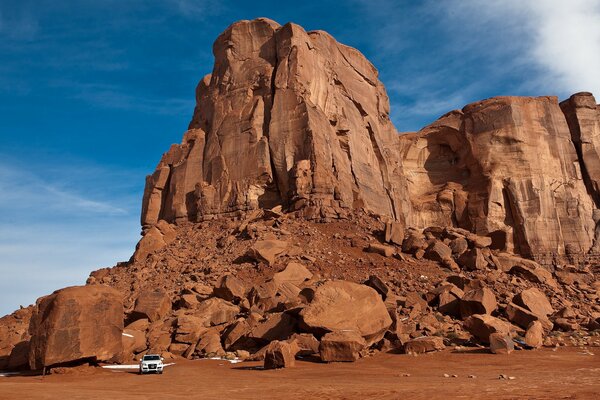 A car in a rocky area during the day