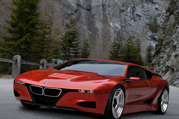 Photo red bmw on the background of rocks