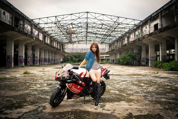 A Yamaha motorcycle. Asian girl posing in the background