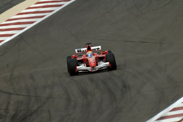 Red racing car in a skid on the track