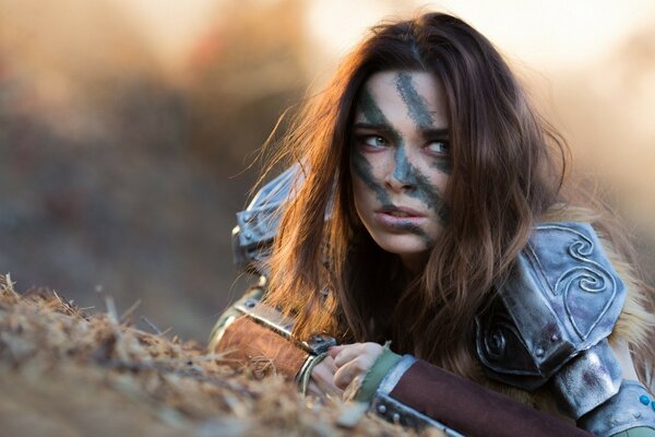 Cosplay brown-haired woman in steel armor