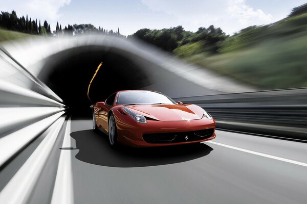 Red Ferrari drives out of the tunnel