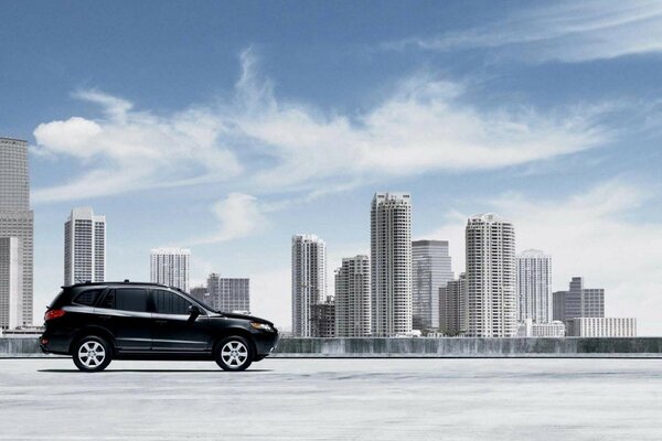 A black car on a city landscape