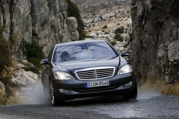 Black mercedes S-class in the mountains