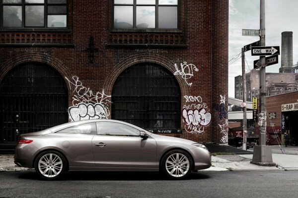 Dark car on the background of urban graffiti